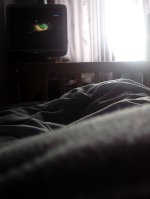 In bed, watching snooker.