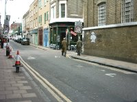 Celebrity con men Gilbert and George wander down a street