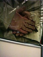 Hands squashed against glass.