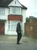A jewish man (not me) wanders past a house. I was in a car waiting at some traffic lights.