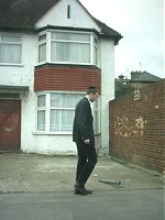 A jewish man (not me) wanders past a house. I was in a car waiting at some traffic lights.
