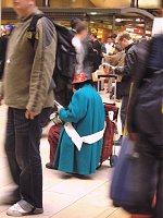 An old woman is sitting among blurs.