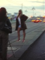 A woman posing as a prostitute for a photoshoot. 