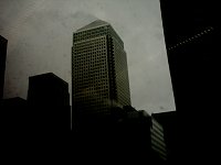 Canary Wharf on a foggy day. It's steam, but it looks like it's on fire.